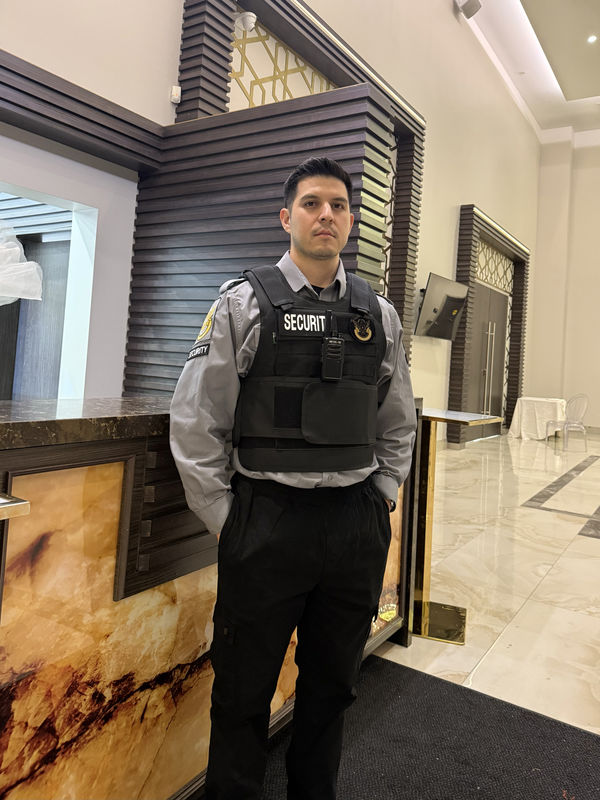 Uniformed Jason's Security concierge guard in an Ontario hotel lobby